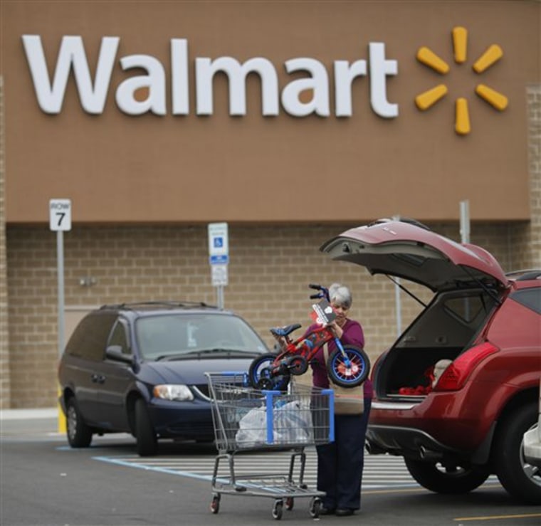 Mary Oksten of Paulsboro, N.J., loads her vehicle outside a Walmart in Deptford, N.J., in this Nov. 10, 2009, file photo. Wal-Mart Stores Inc. reported Tuesday that its first-quarter net income rose 10 percent.